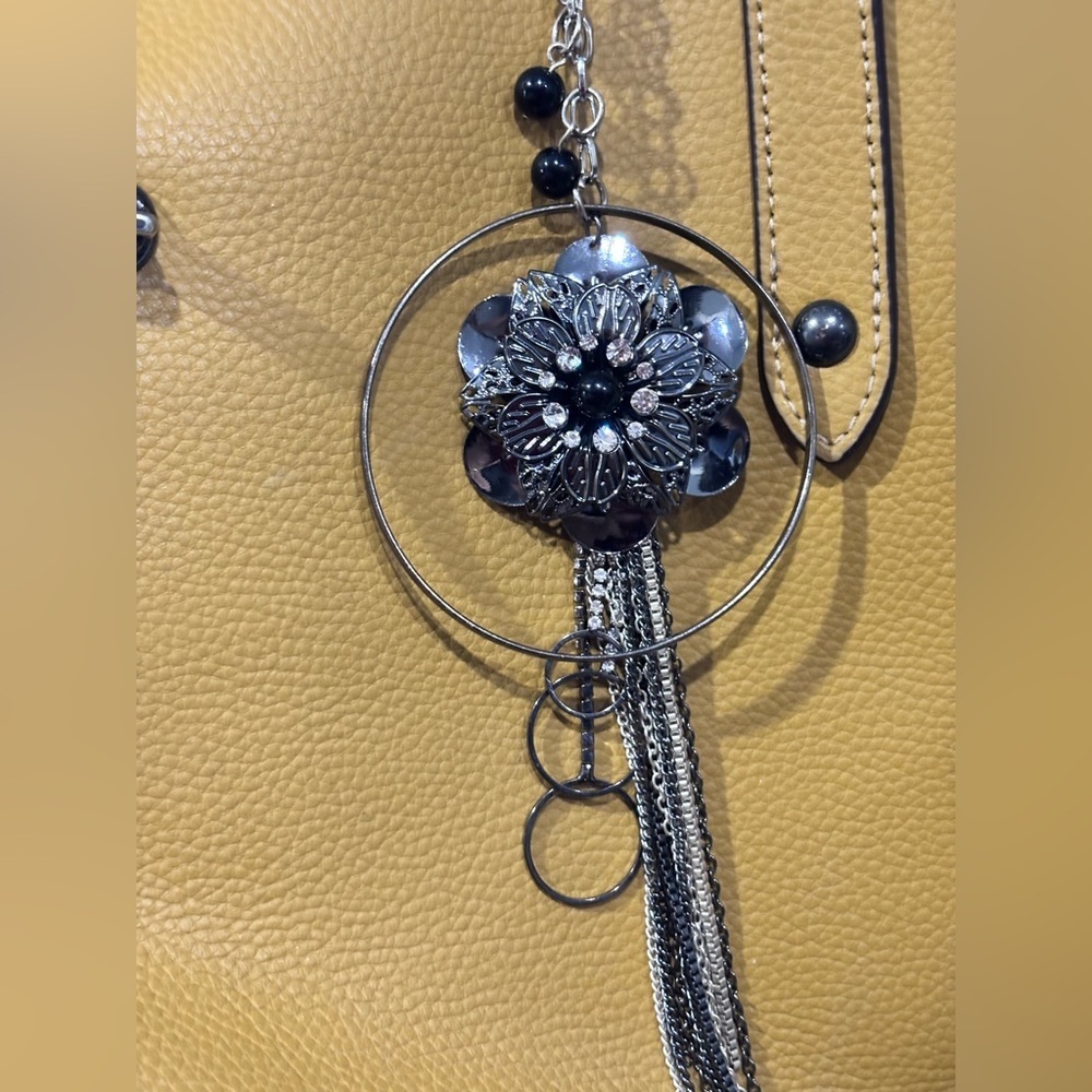 Large, black and silver, boho-inspired bag charm with a touch of glamour